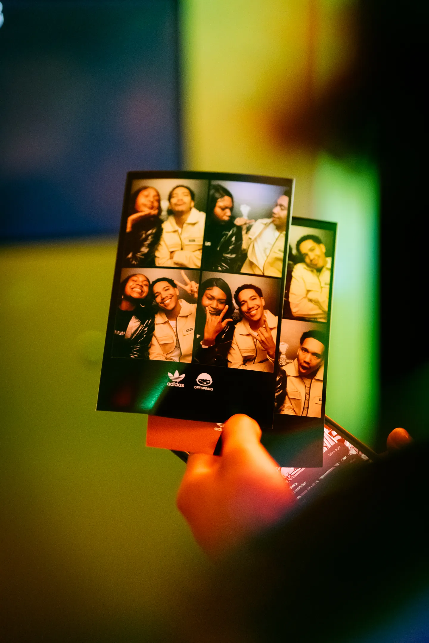 Photo booth strip with four images of a smiling young man and woman posing playfully together.