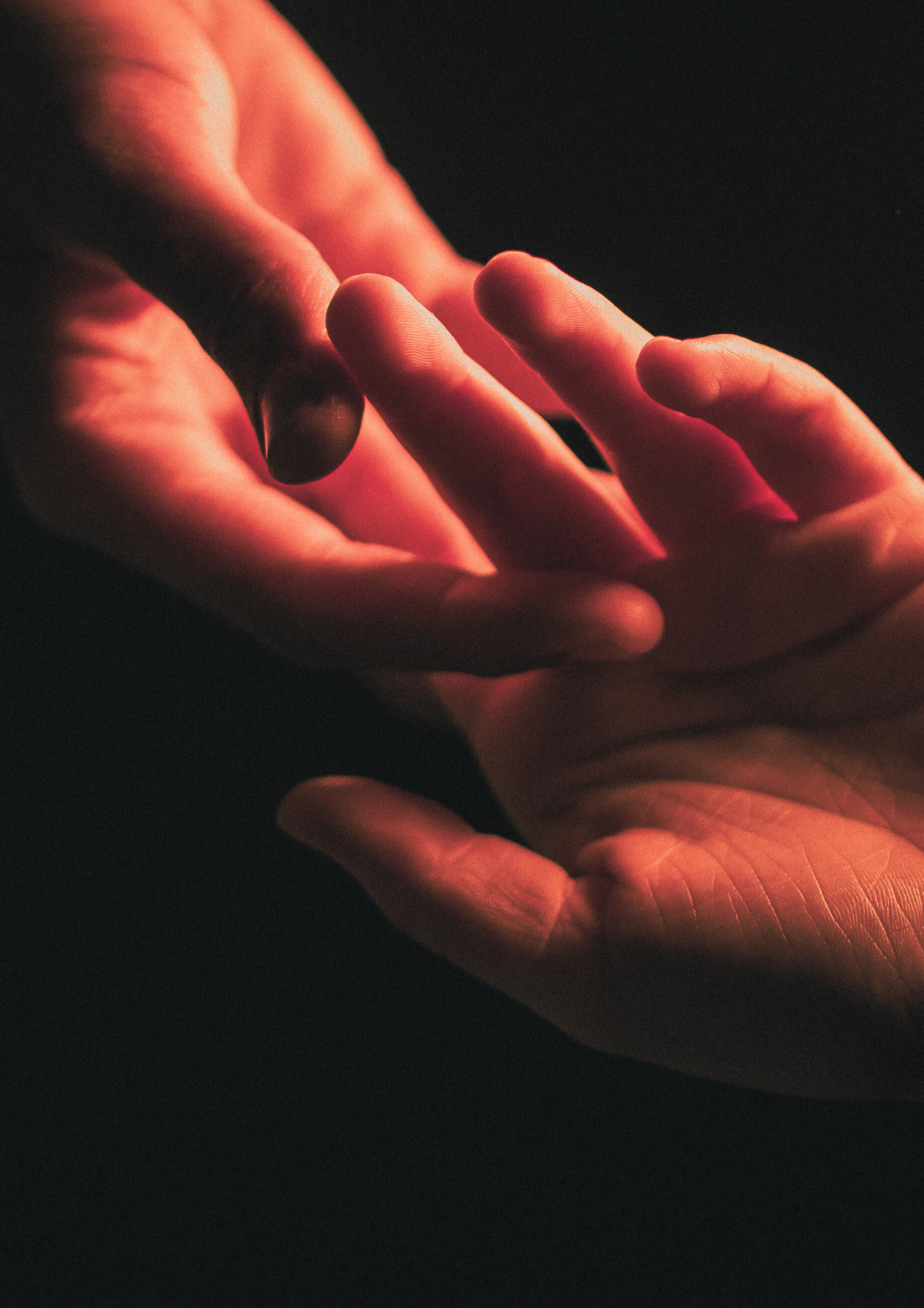 Two hands reaching out and touching one another.