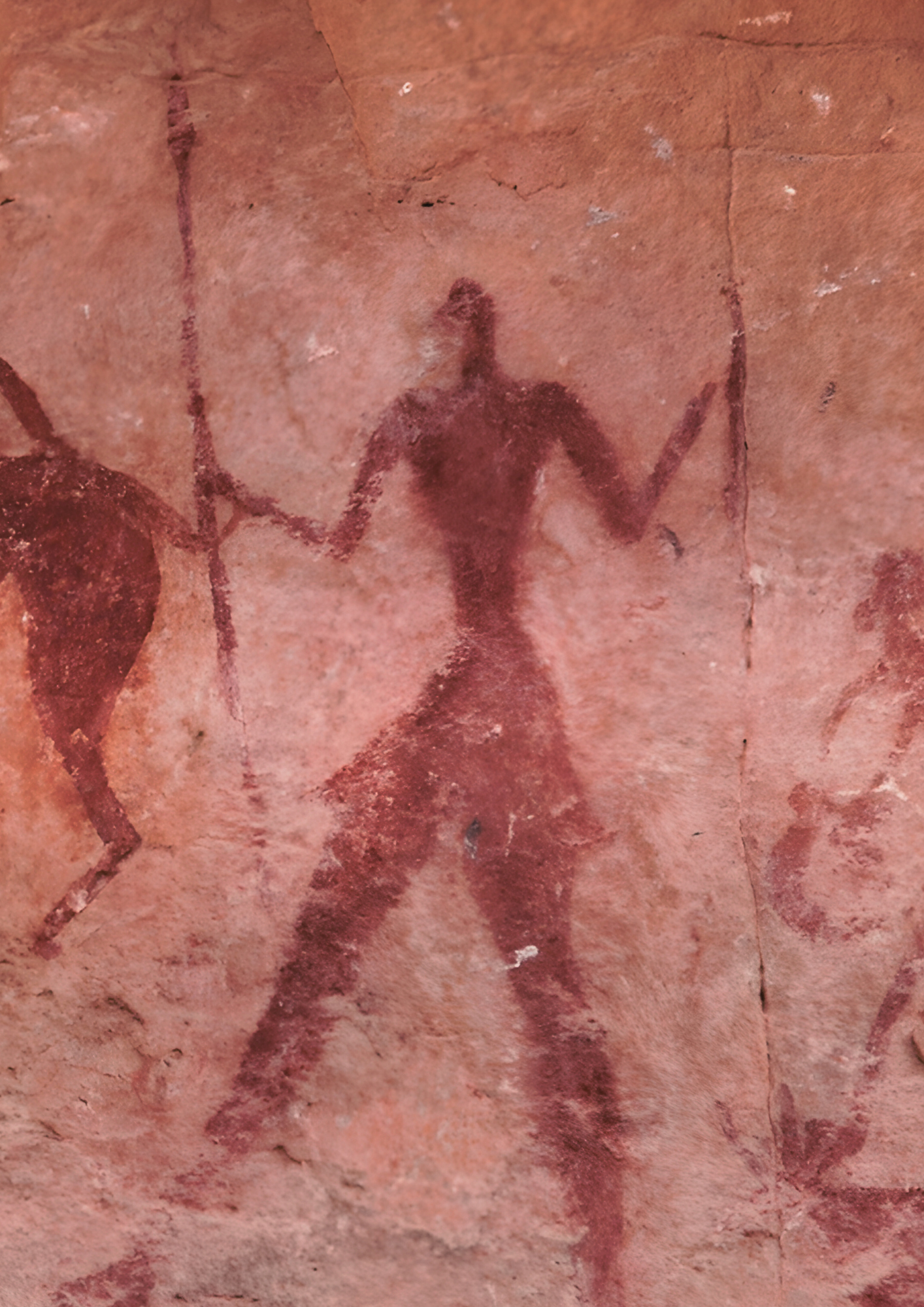 A cave painting of a man with daggers.