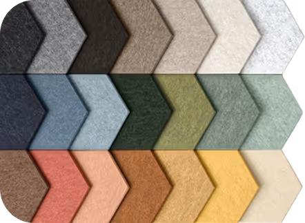 Grid of PET felt acoustic wall tiles in chevron shapes across varied color tones.
