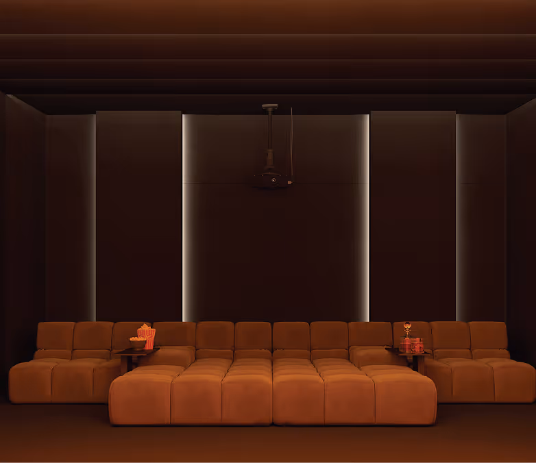 Acoustically treated home cinema room with tan modular seating and softly backlit fabric wall panels.