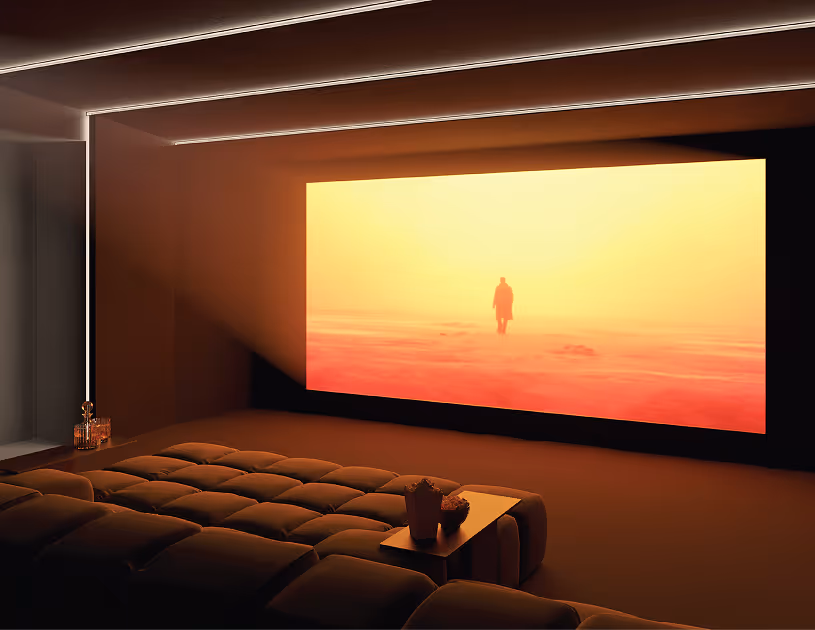 Acoustic home cinema with large screen and tiered seating in a softly lit panel-lined room.