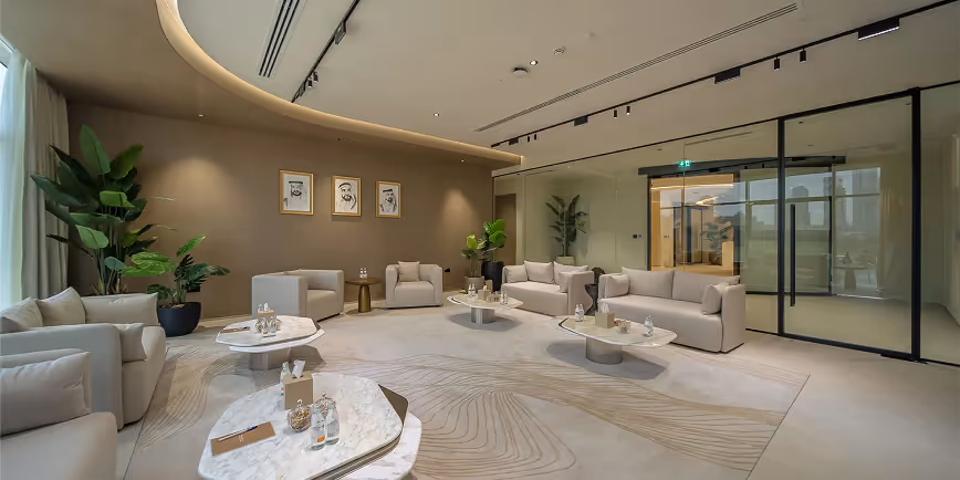 Elegant majlis lounge with acoustic-treated walls, curved ceiling, and beige sofas.