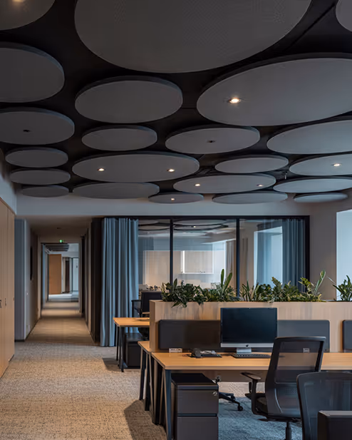 Terracotta ribbed acoustic wall tiles in a sunlit dining area.