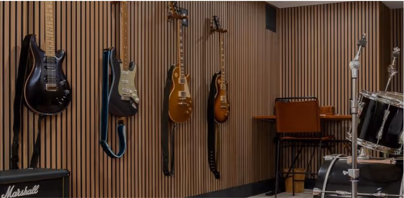 Wood-slat acoustic wall in a dining setting with a vase and candles.