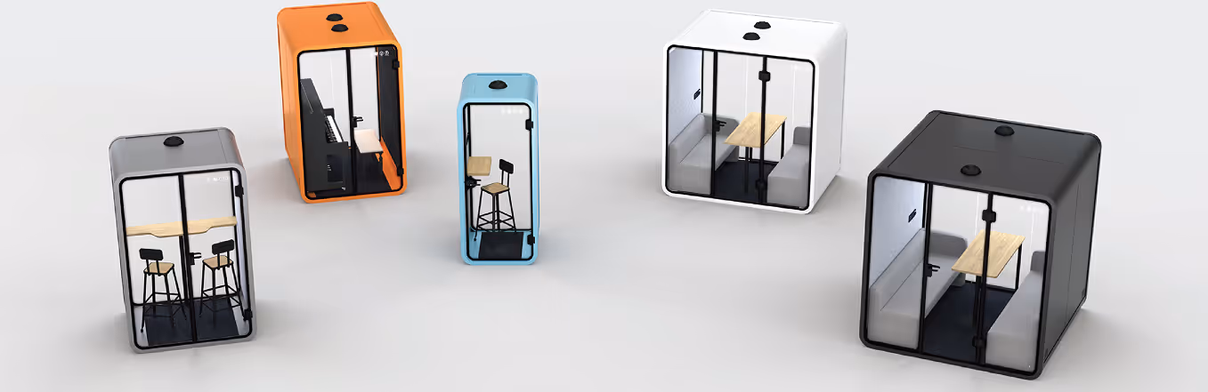 Range of acoustic phone booth pods in black, white, orange and blue with desks inside.