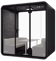 Black acoustic meeting pod with seating, table and ventilation for open-plan offices.