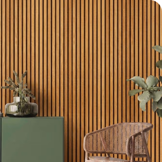 Living room with a golden oak acoustic wood slat wall, green sideboard, vase and rattan chair.