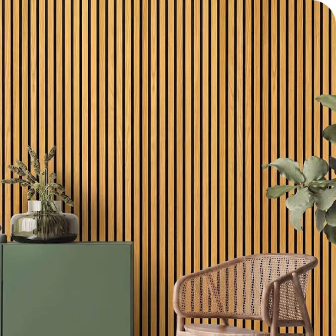 Living room with a light oak acoustic wood slat wall, green sideboard, vase and rattan chair.