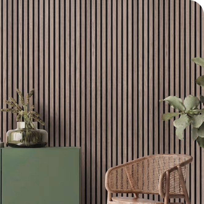 Living room with a smoked brown acoustic wood slat wall, green sideboard, vase and rattan chair.