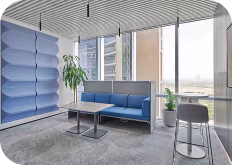 Lounge with blue wavy 3D acoustic wall panels, a sofa bench and a city-view window.