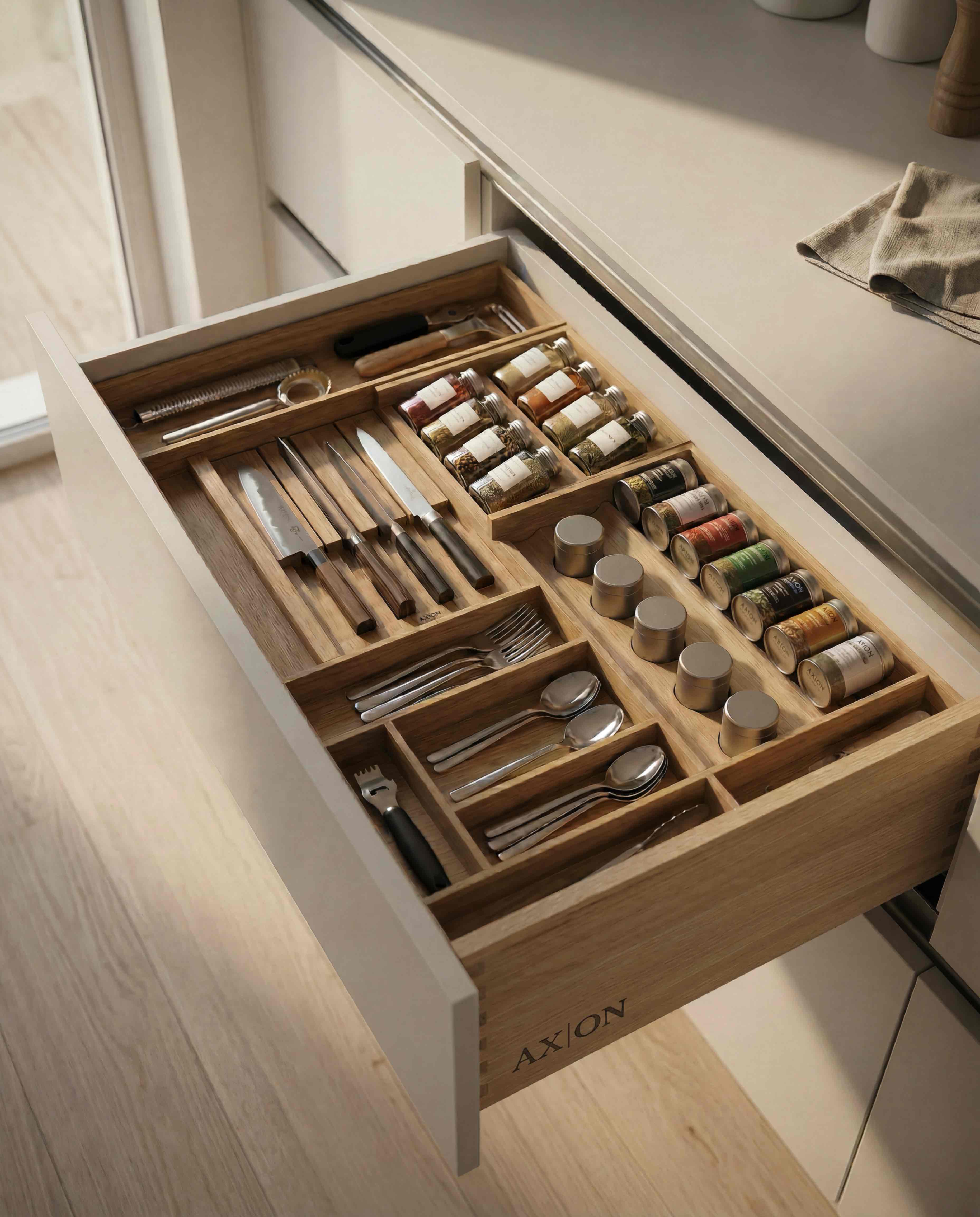 Luxury kitchen drawer organization with knives, cutlery and spices in custom wooden insert
