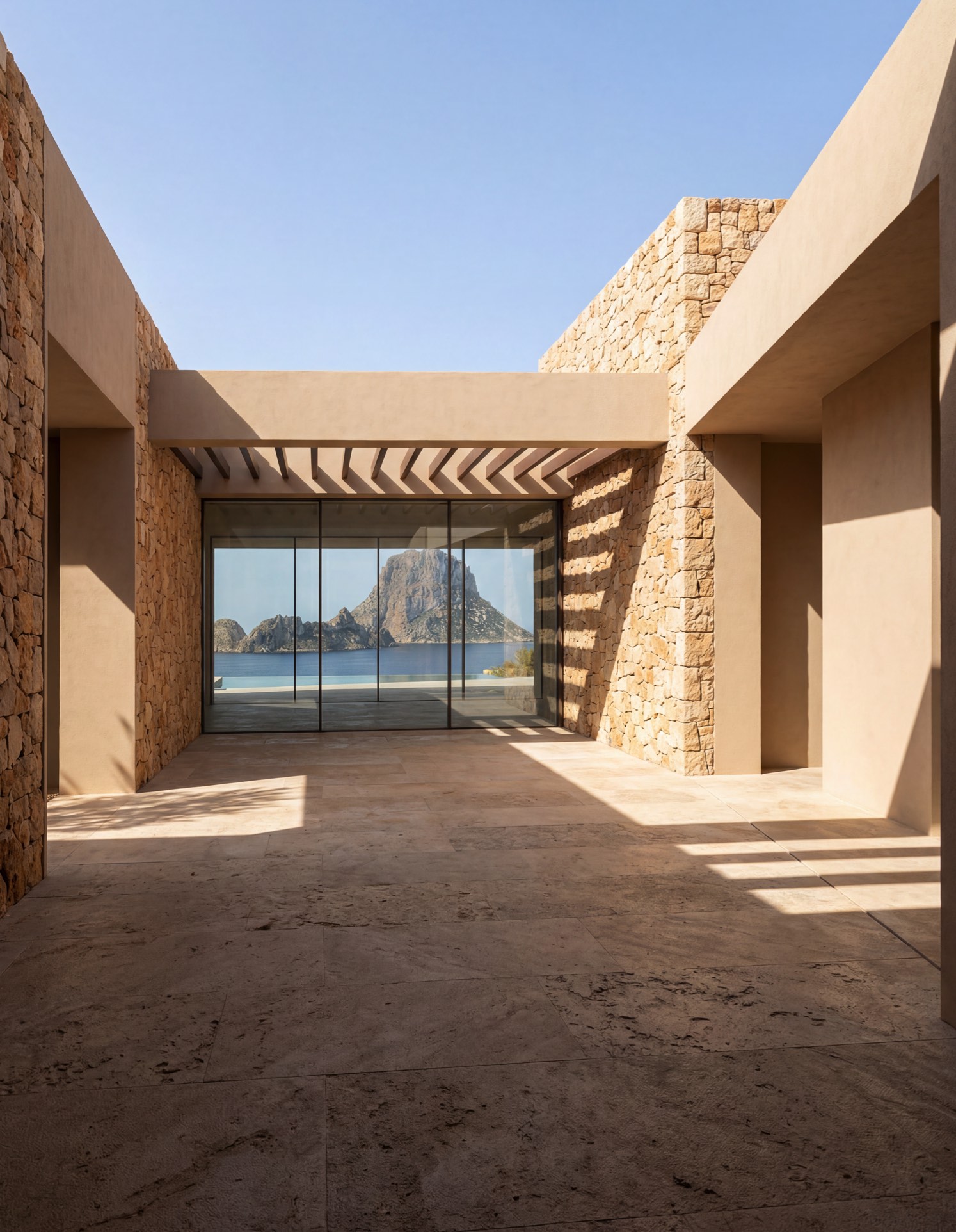 Minimalist Mediterranean architecture with natural stone and geometric light in Mallorca, representing AX ON design precision