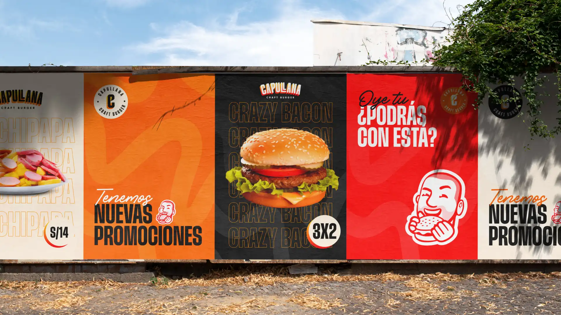 Carteles publicitarios exteriores de Capullana Craft Burger mostrando varias promociones y una gran hamburguesa Crazy Bacon
