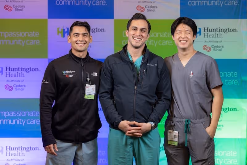 Hospital teammates collaborating in a clinical corridor.