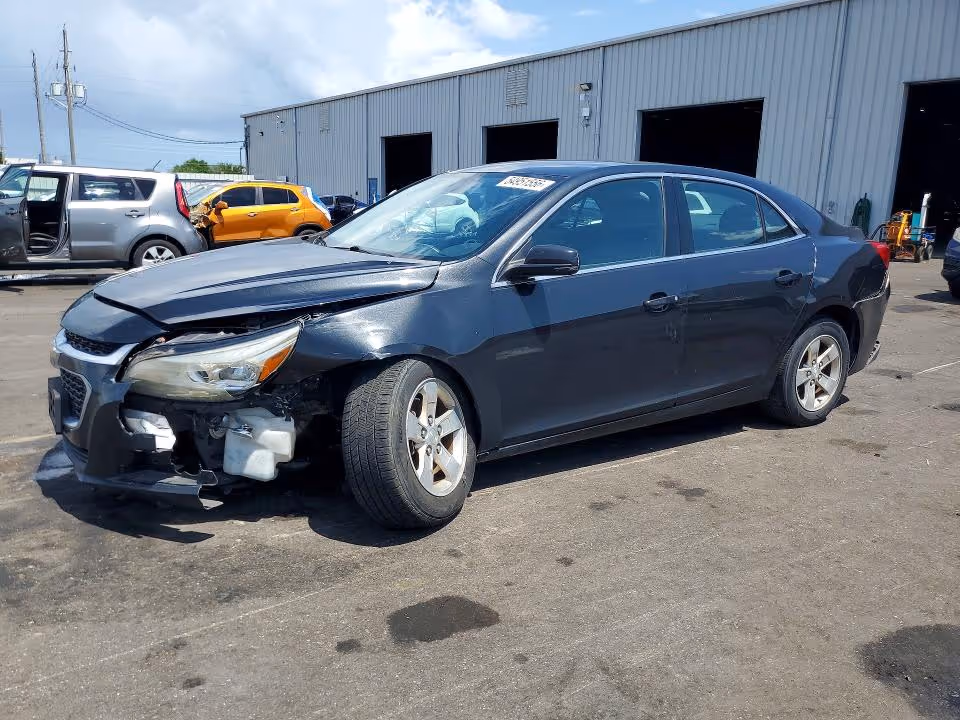 Unclaimed blue 2014 Chevy Malibu sitting in a car dealership lot