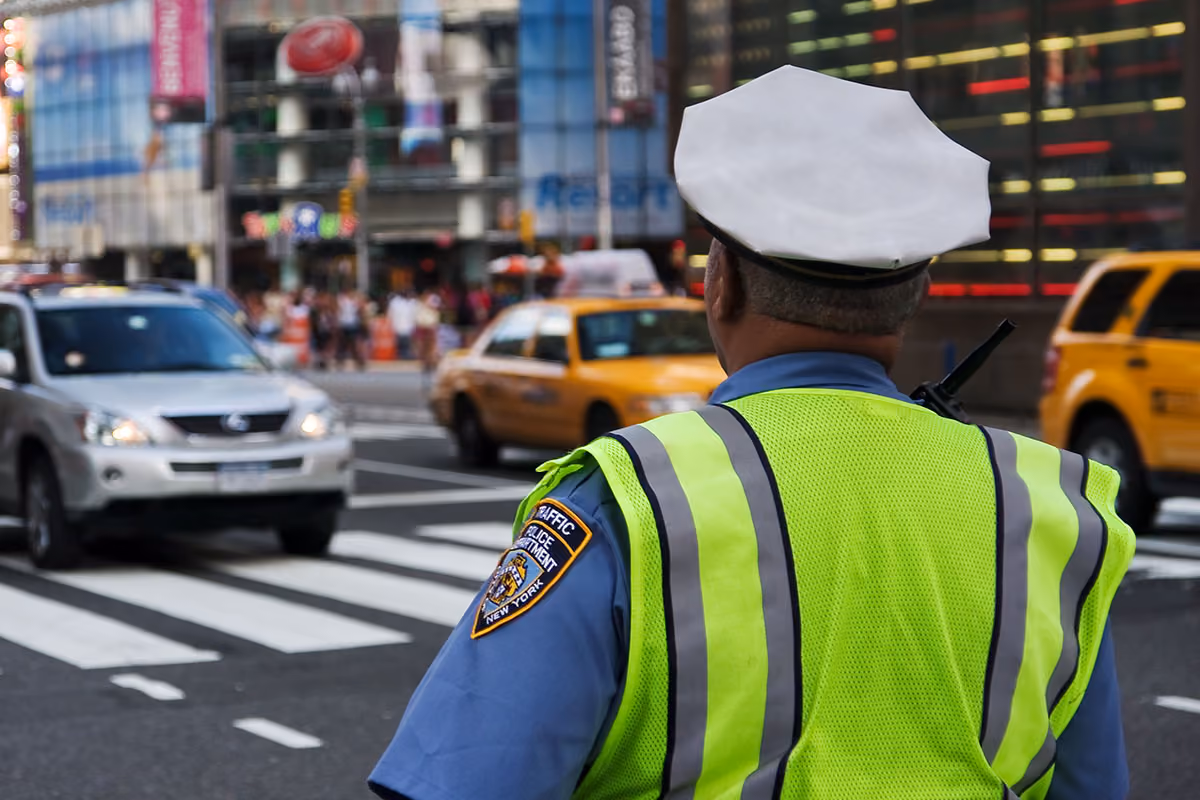 Police officer in high visibility vest directing traffic in New York City