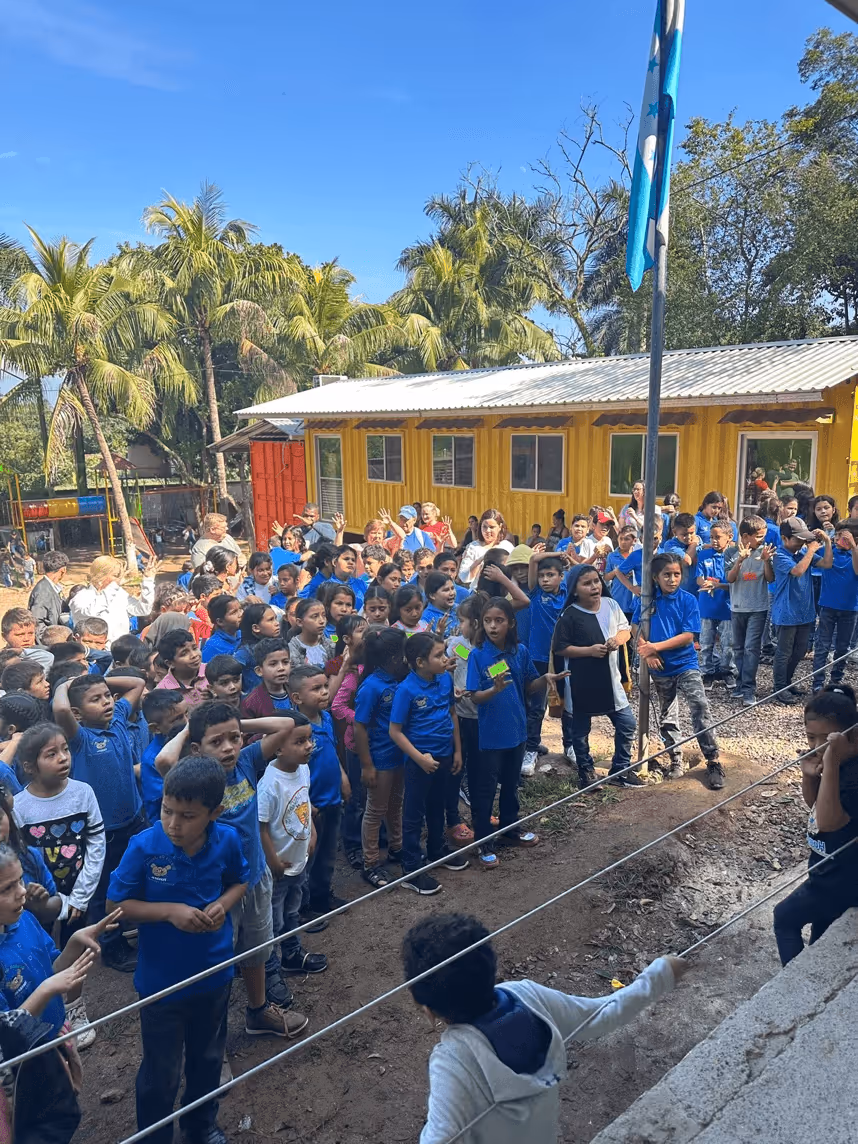 A group of children standing in a lineAI-generated content may be incorrect.