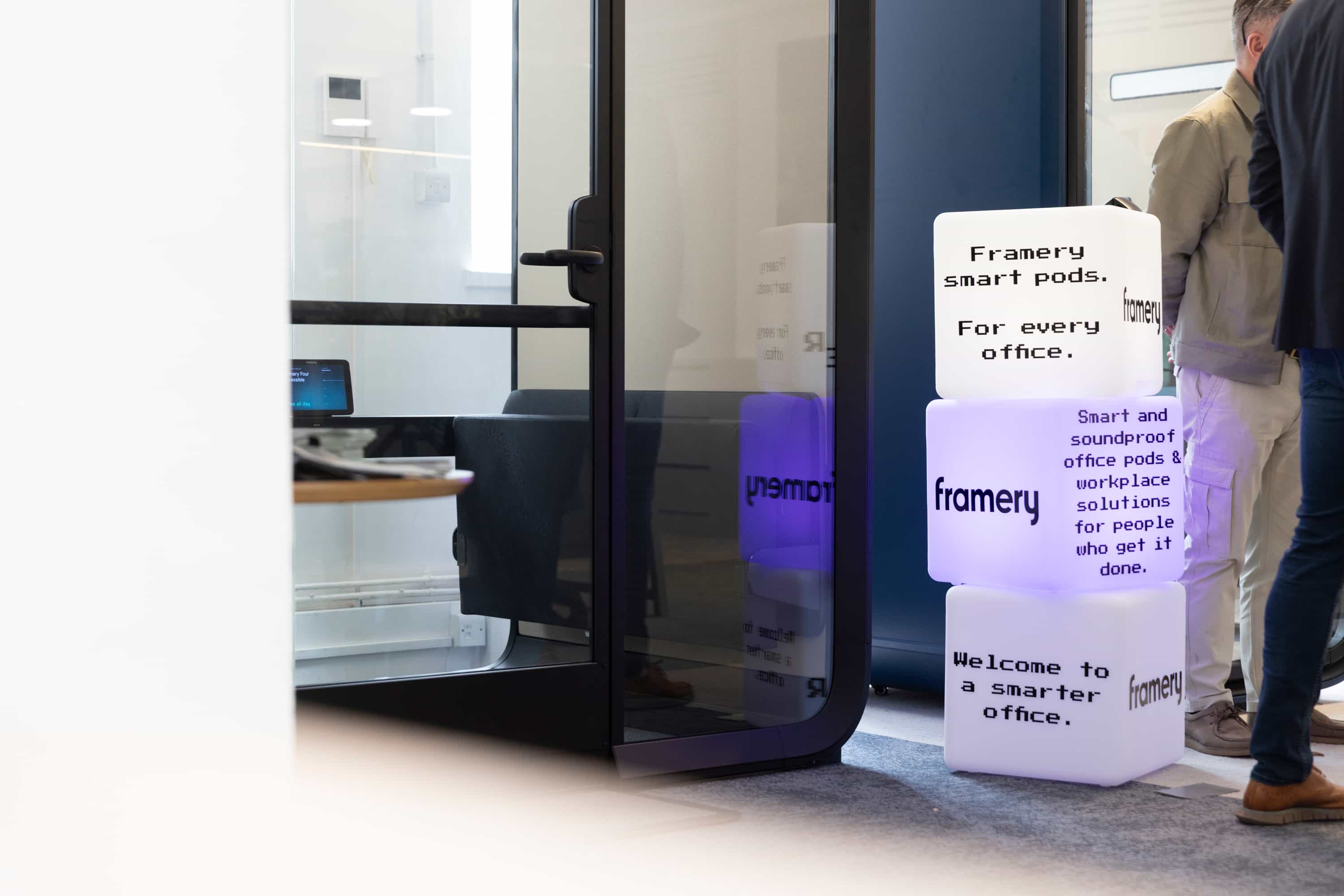Retro-inspired neon light blocks promoting Framery acoustic office pods.