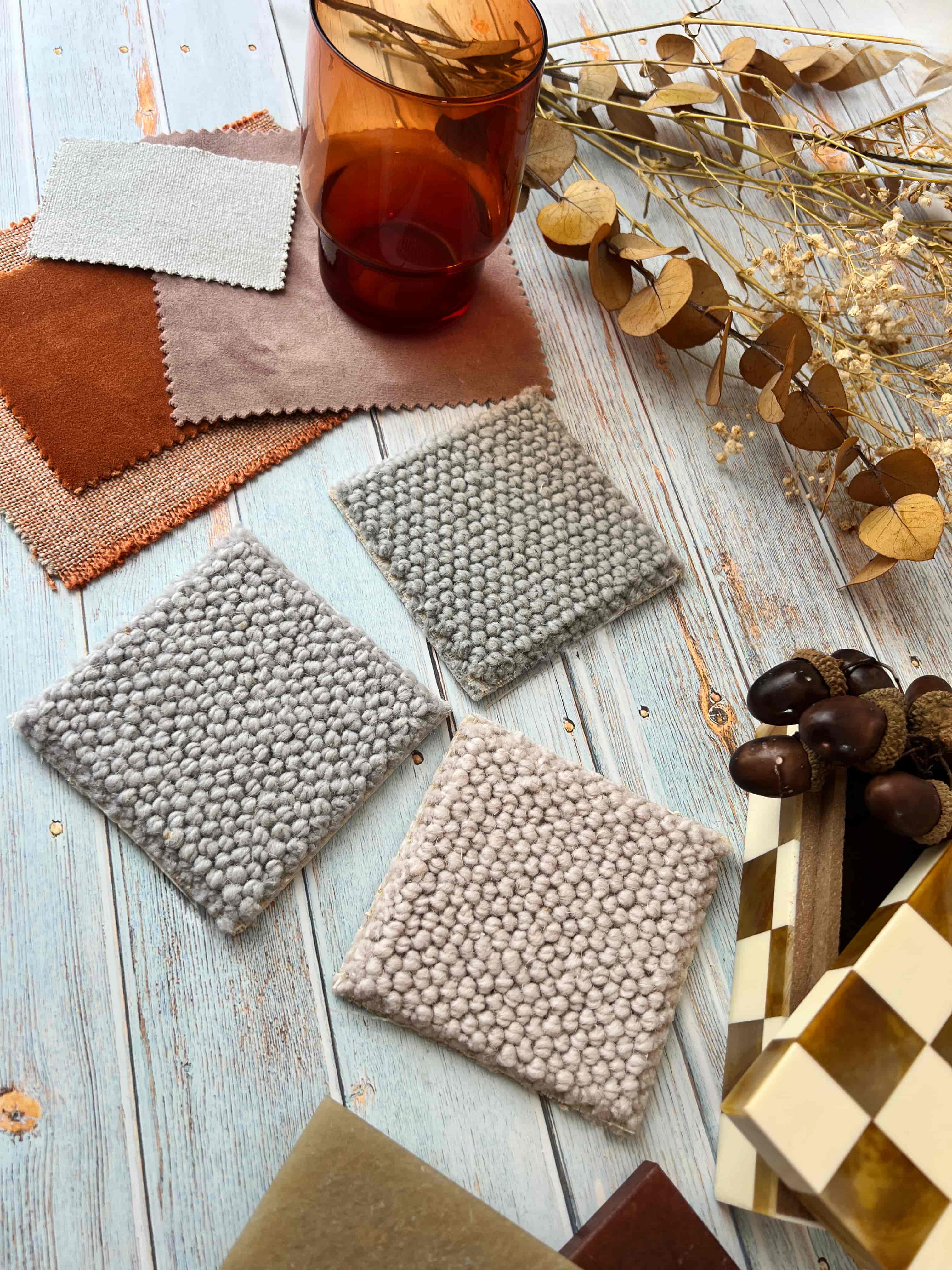 A moodboard creatively displaying wool carpet samples on a wooden background.