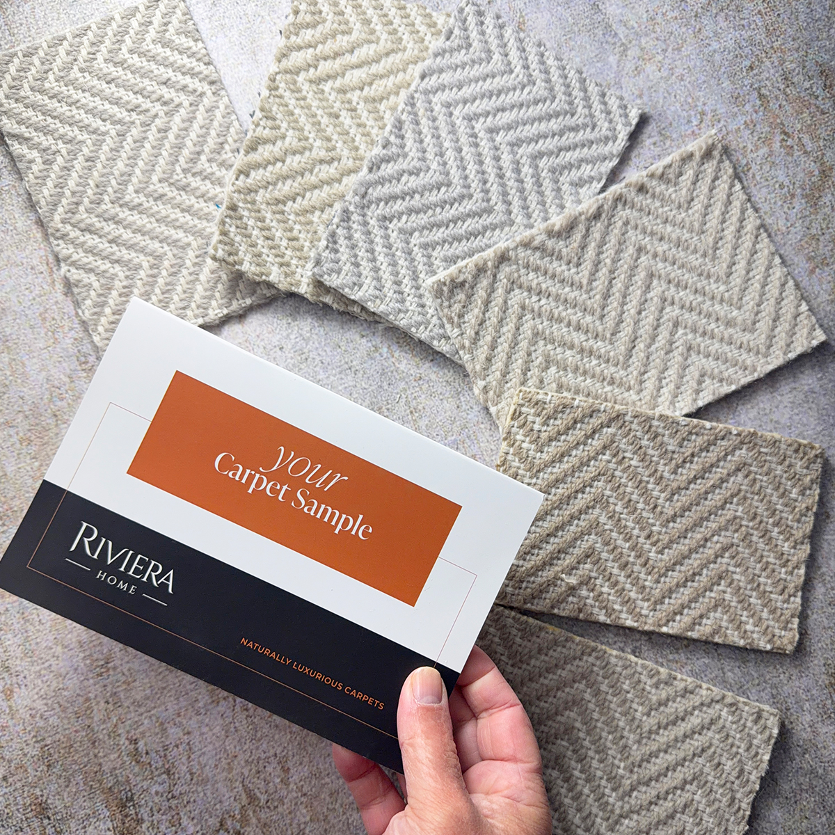 A spread of carpet samples behind a small leaflet promoting a free sample service.