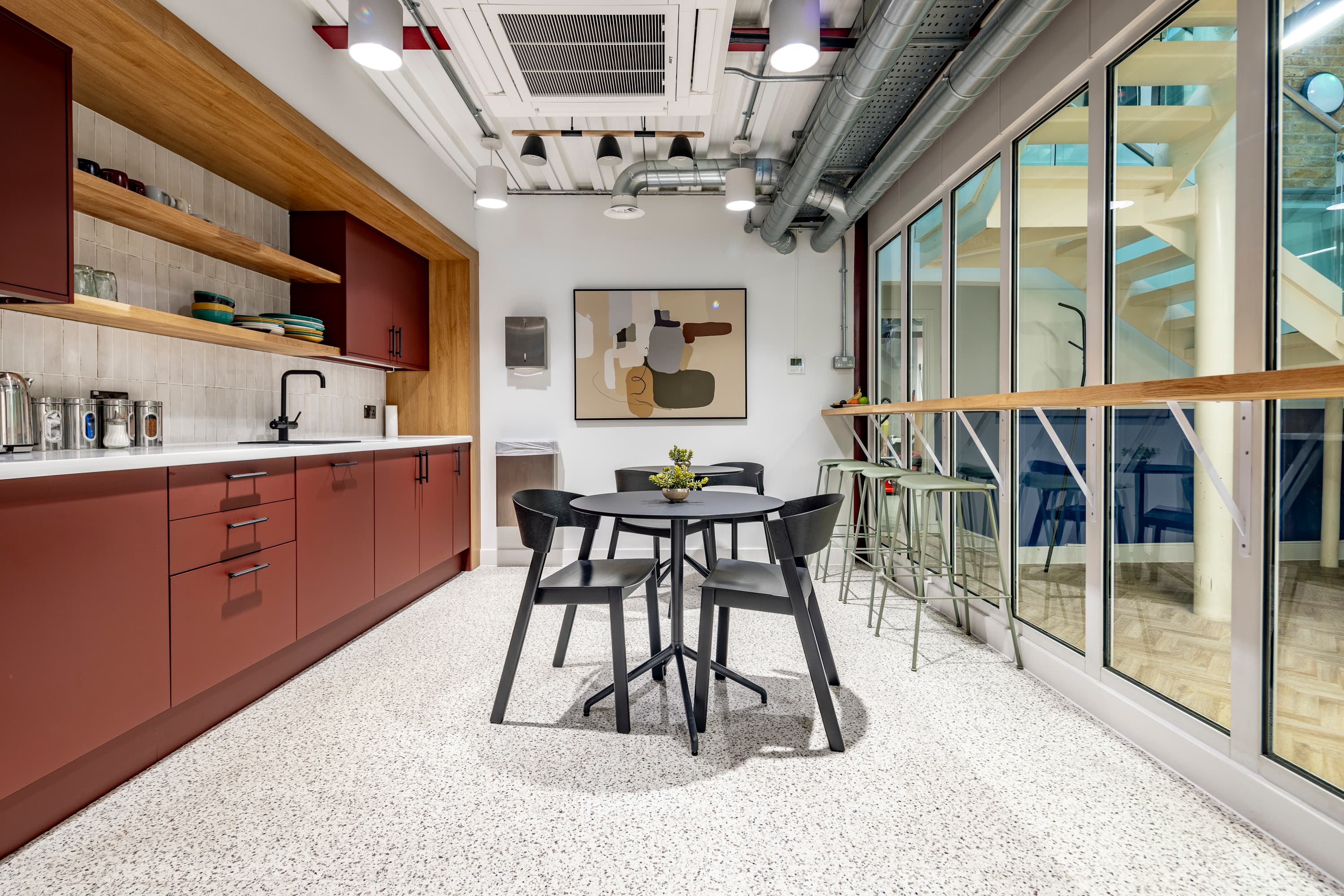 A case study image showing a newly-refurbished kitchen and dining area in a commercial space.