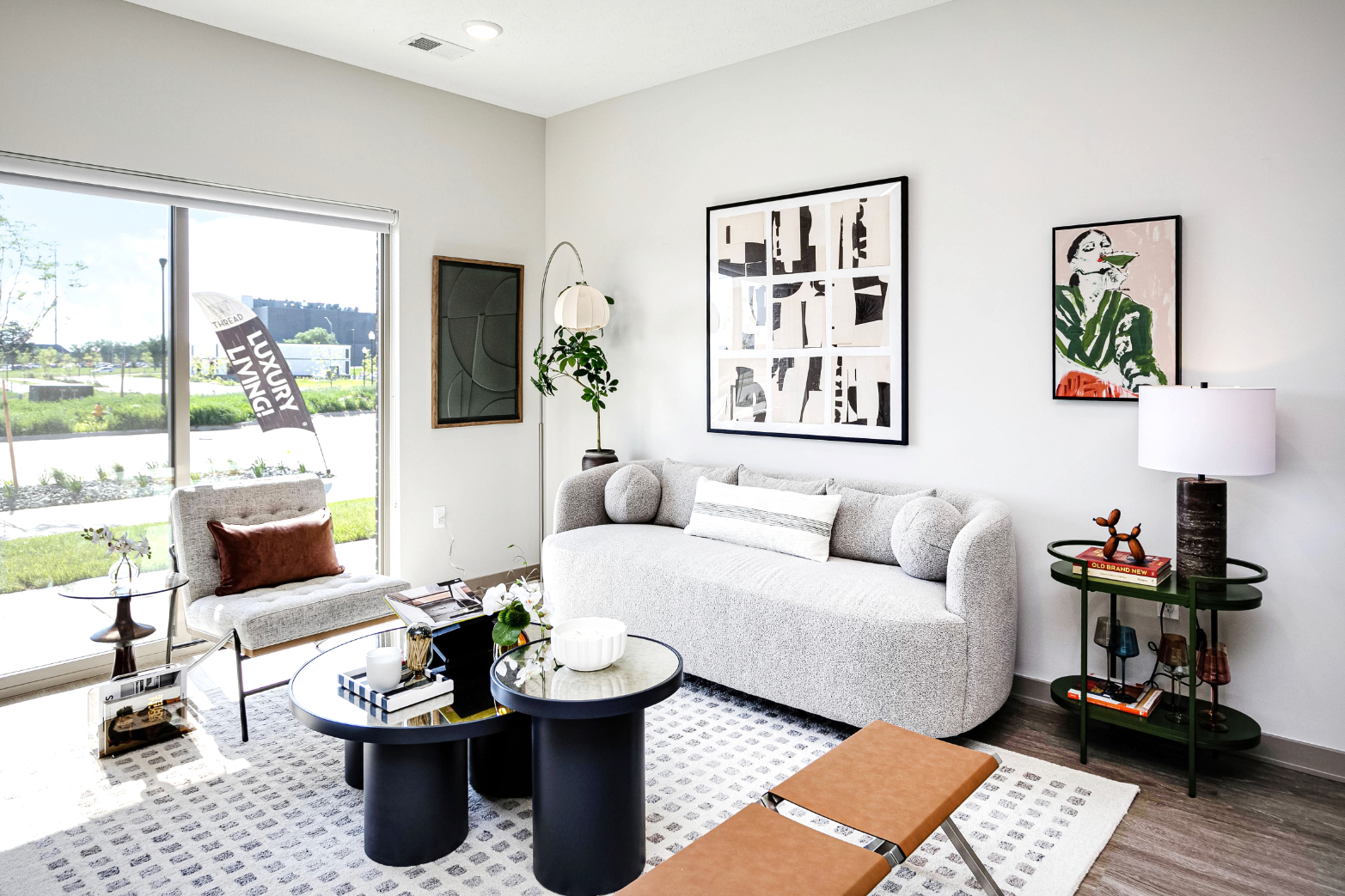 Living area with contemporary decor featuring sofa, coffee table, and lamp
