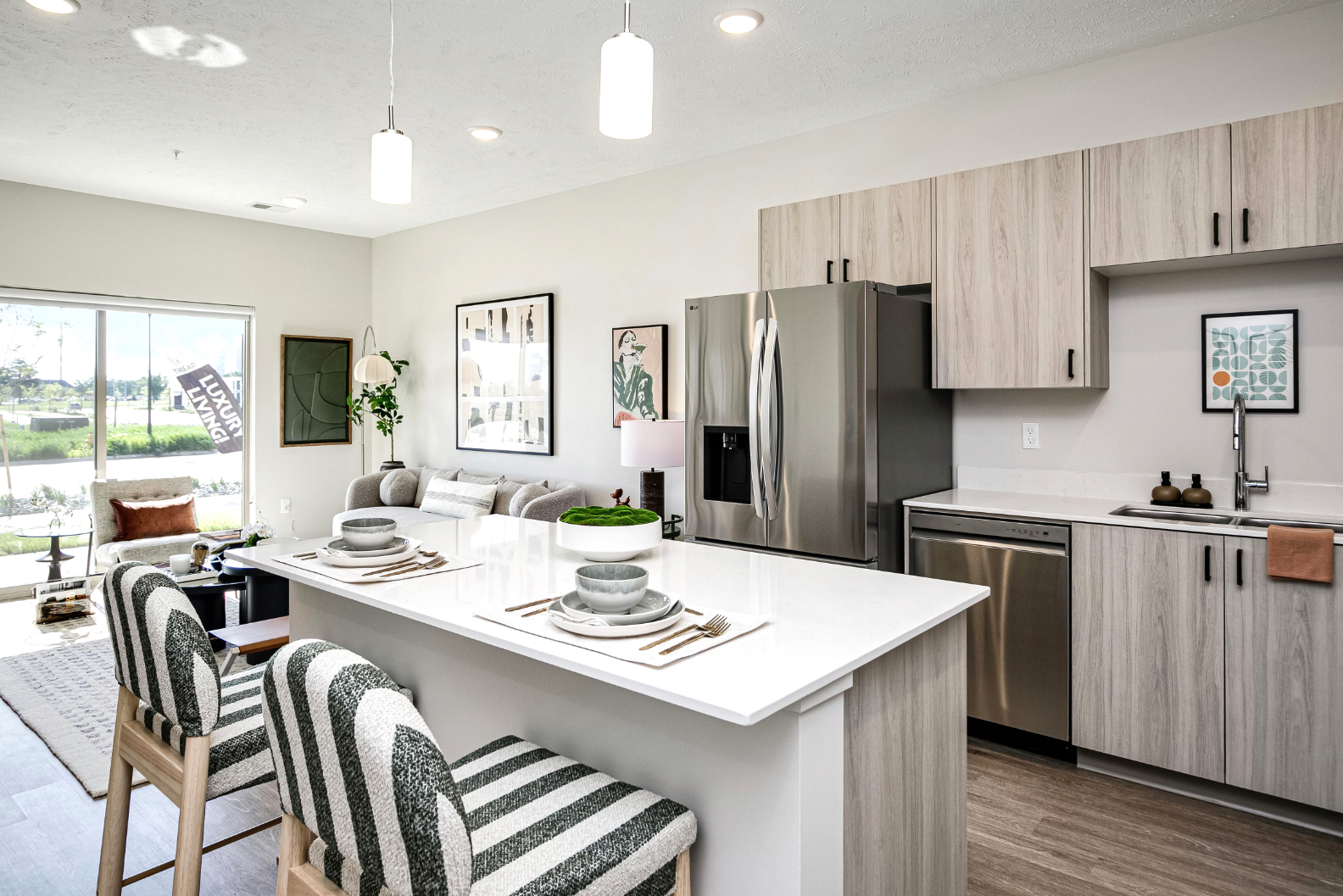 Kitchen with island, stainless steel appliances and living area with sofa