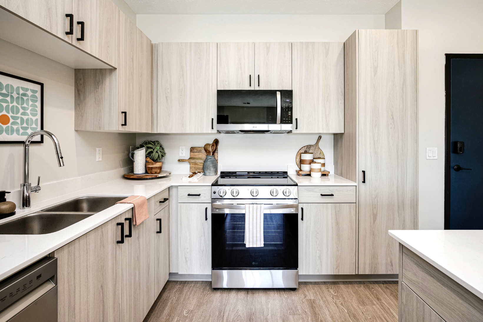Kitchen with light wood cabinets and stainless steel appliances