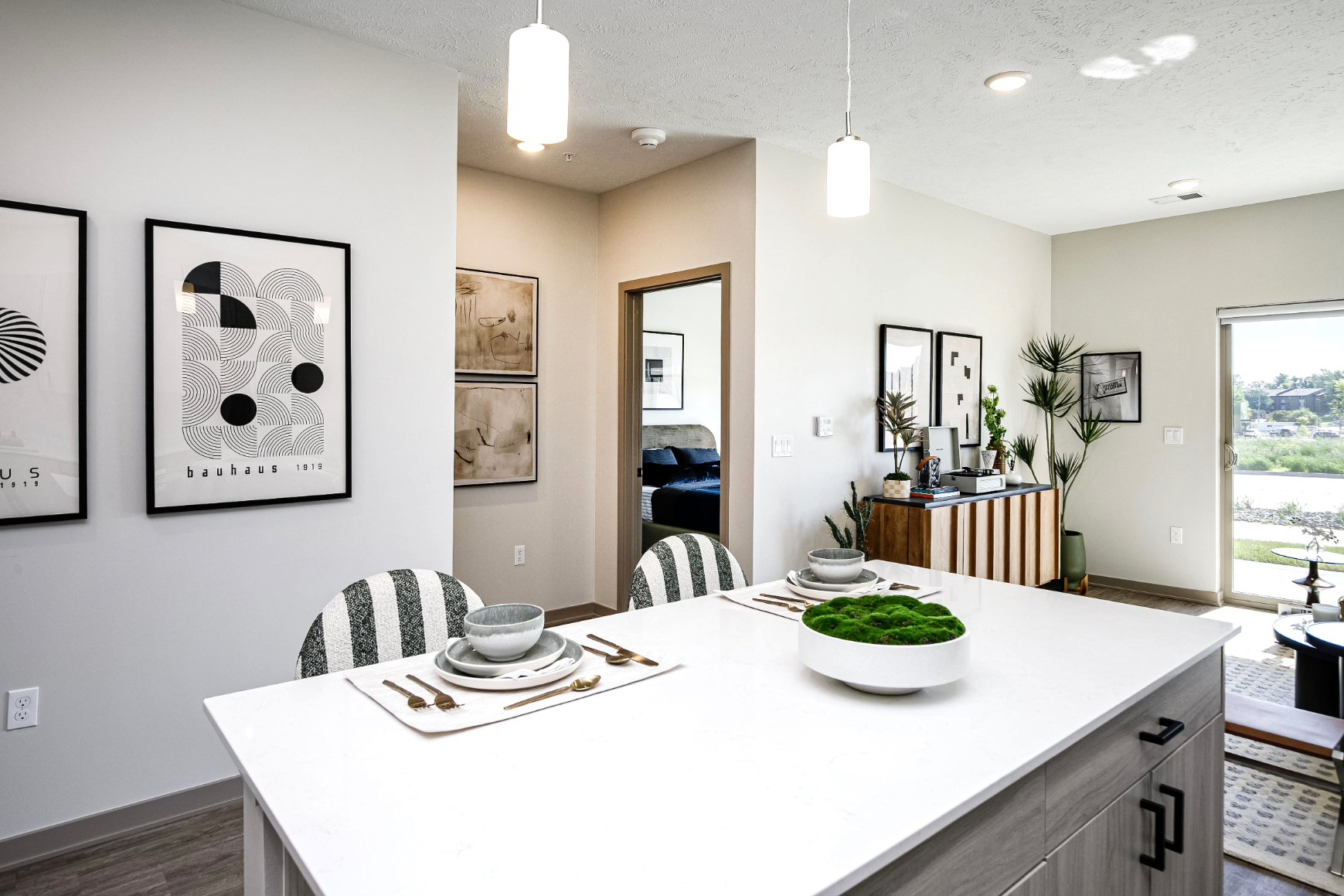 Kitchen with island and view into bedroom
