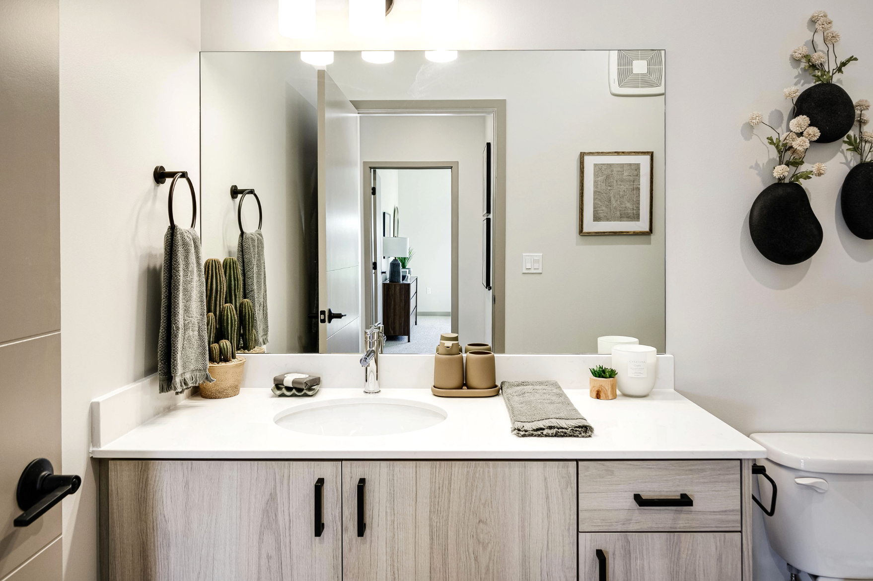 Bathroom with white cabinets and vanity with mirror
