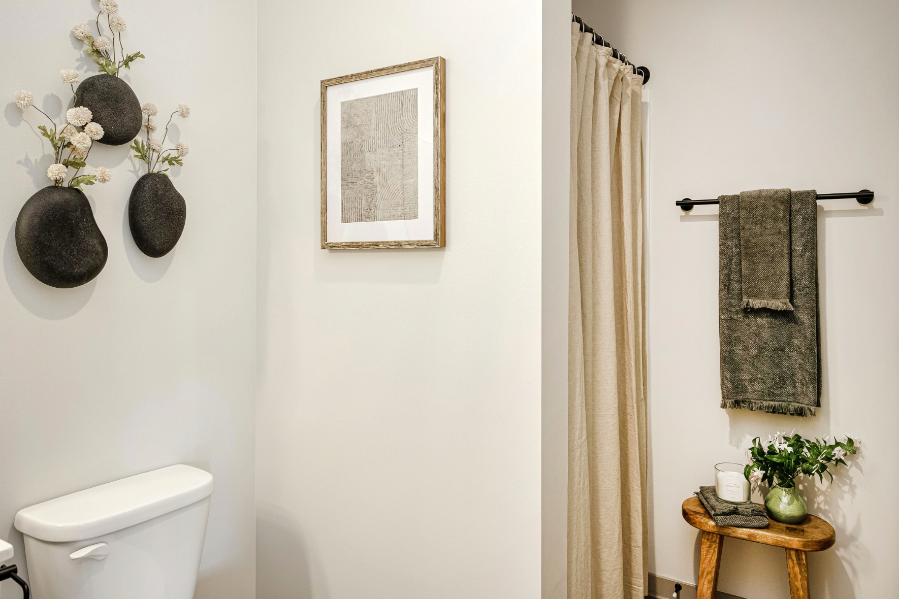 Bathroom with plant and wall decor
