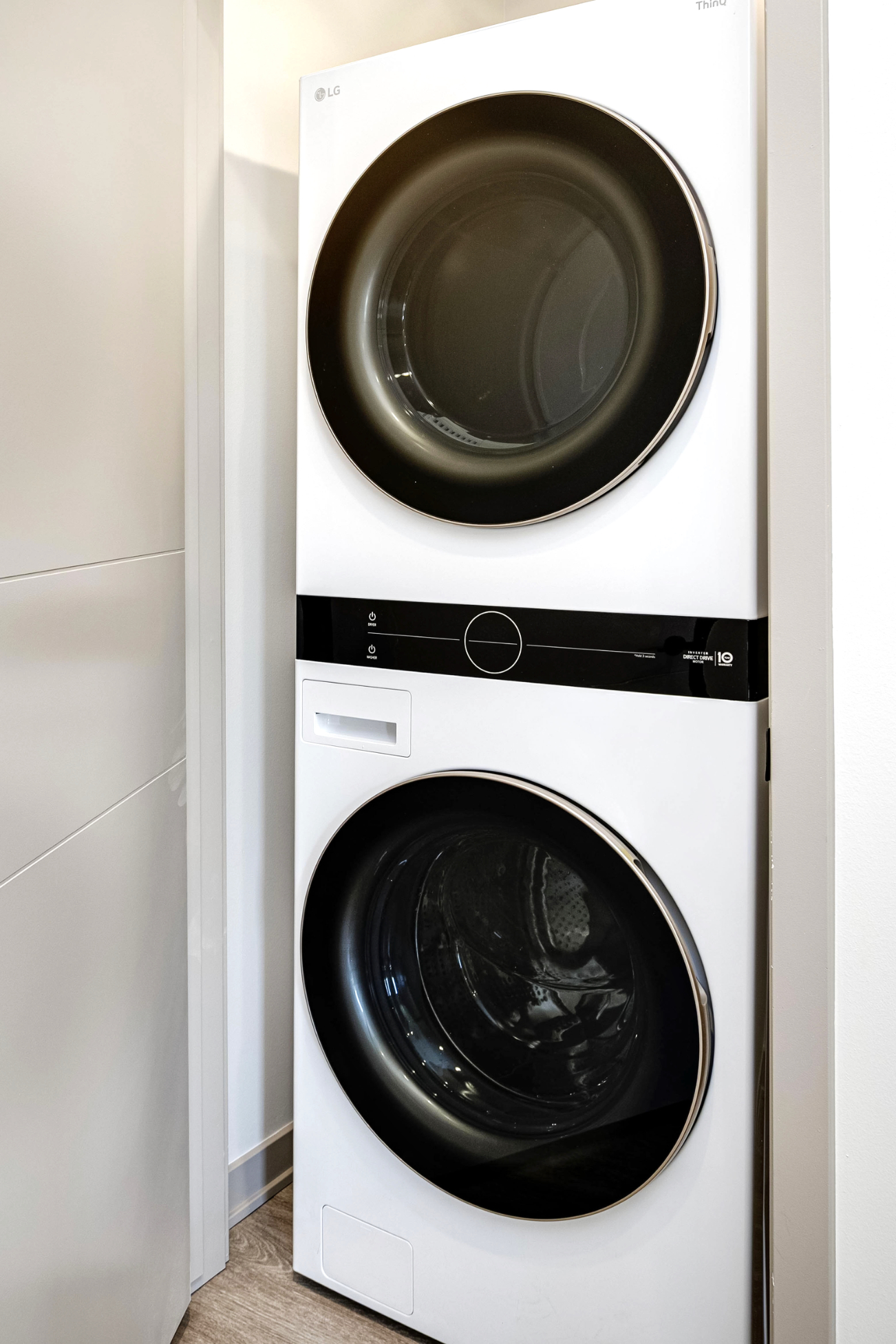Laundry room with stacked appliances