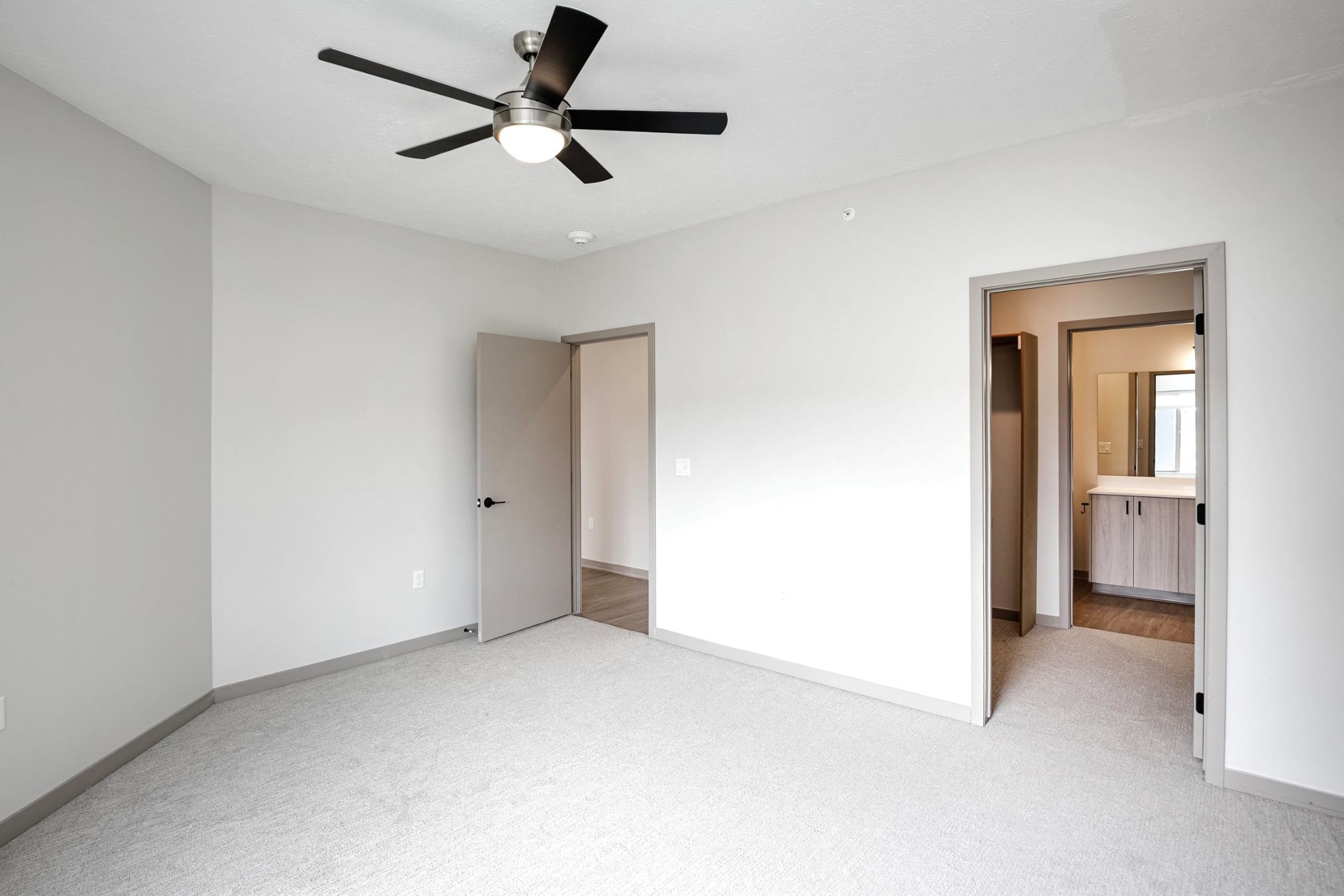 Unfurnished bedroom with view into bathroom