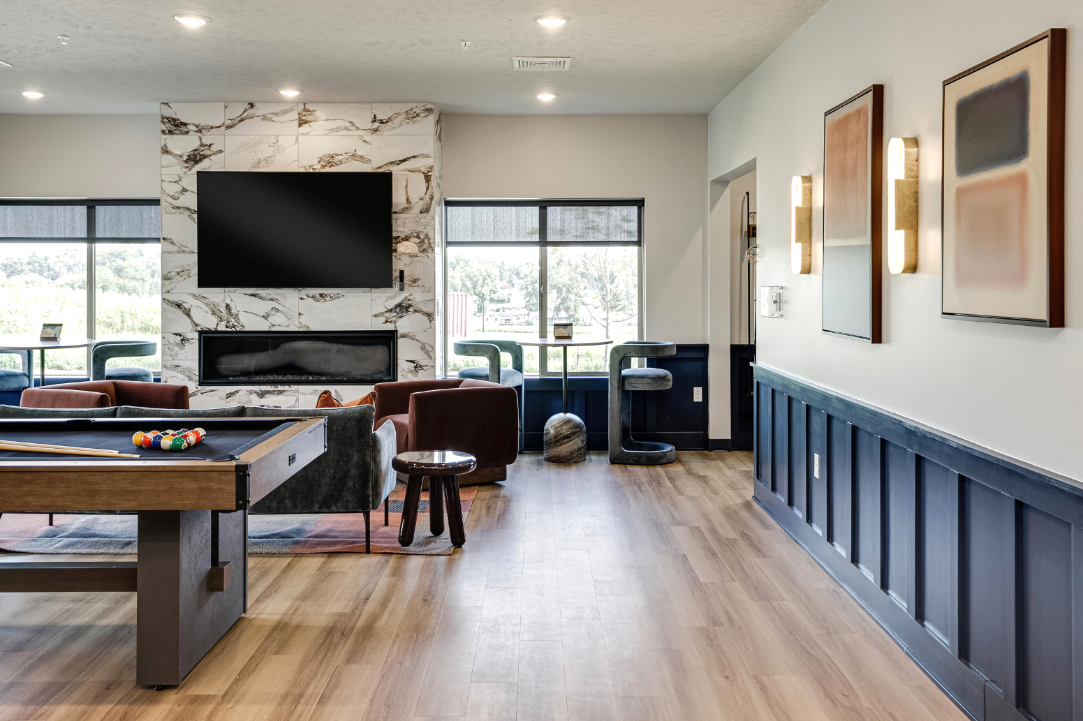 Clubhouse game area with billiards table, tv, and fireplace