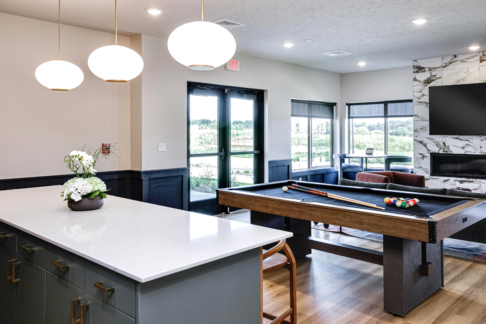 Clubhouse game area with billiards table, tv, and fireplace