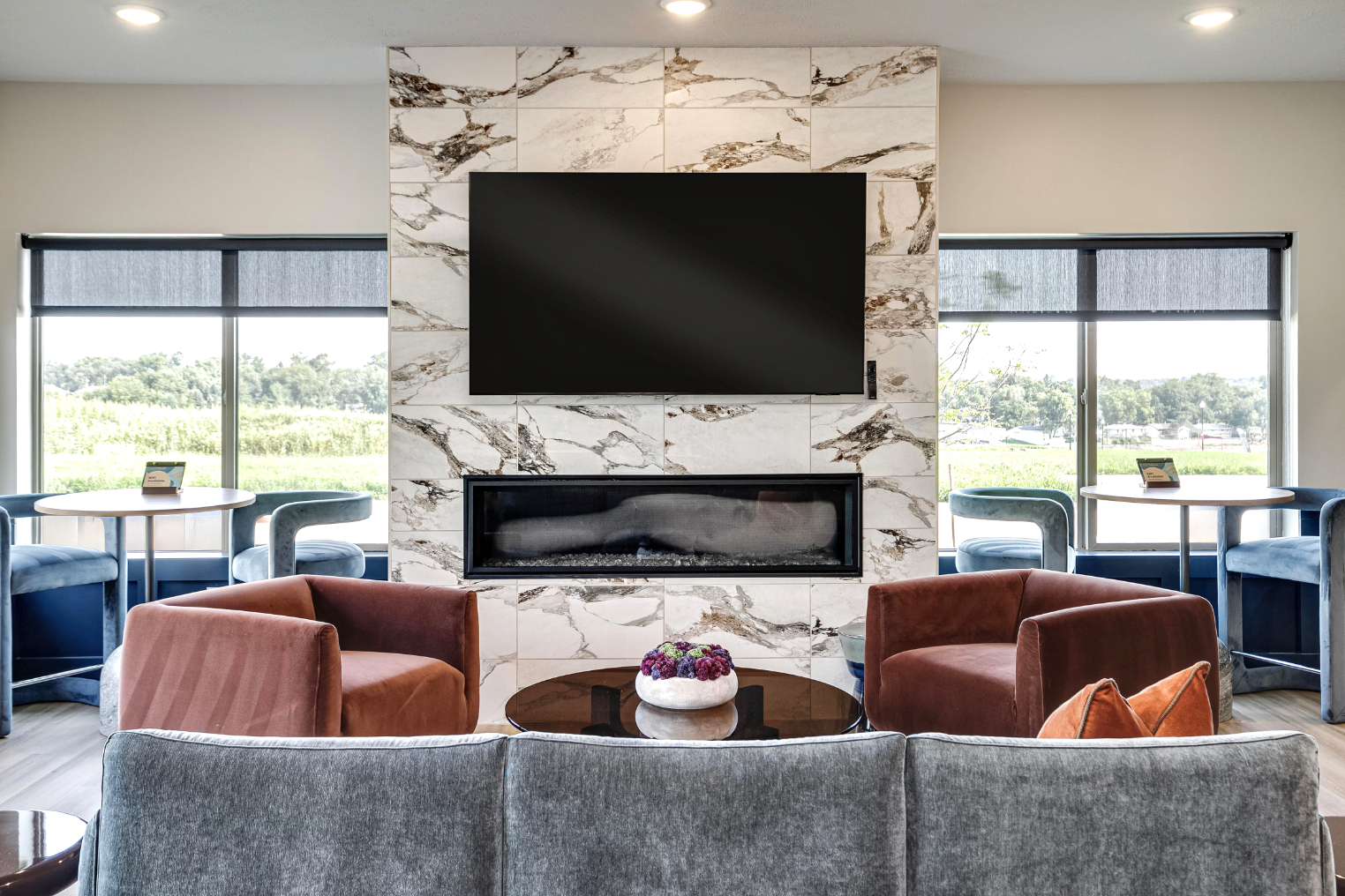 Clubhouse lounge area with tv, and fireplace
