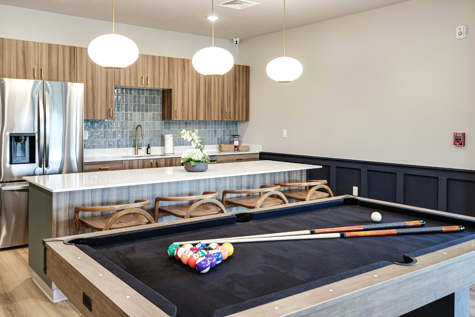 Clubhouse lounge area with view of kitchen and billiards table