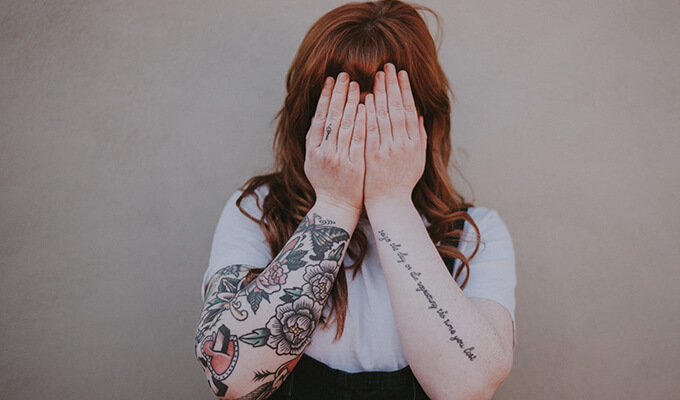 girl hiding her face wants to hide creativity