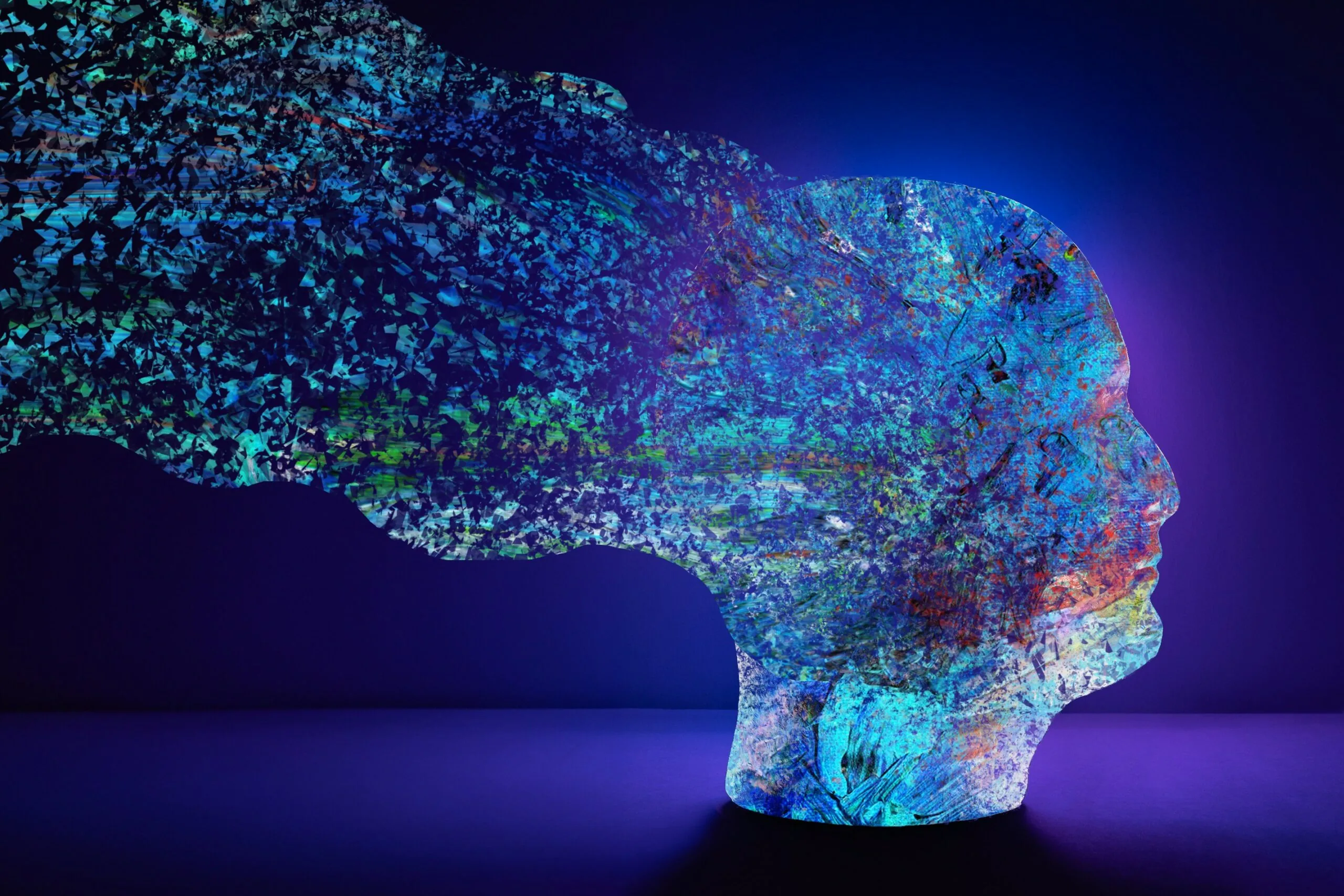 Colorful fragmented head profile showing neural patterns and processing