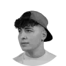 Portrait of a young person wearing a backward baseball cap with a neutral expression.