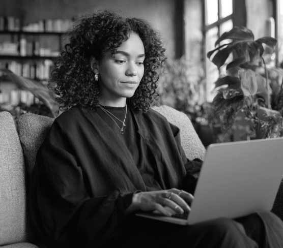 Woman Working On Laptop On Sofa PromptEngine Webflow Template | BRIX Template