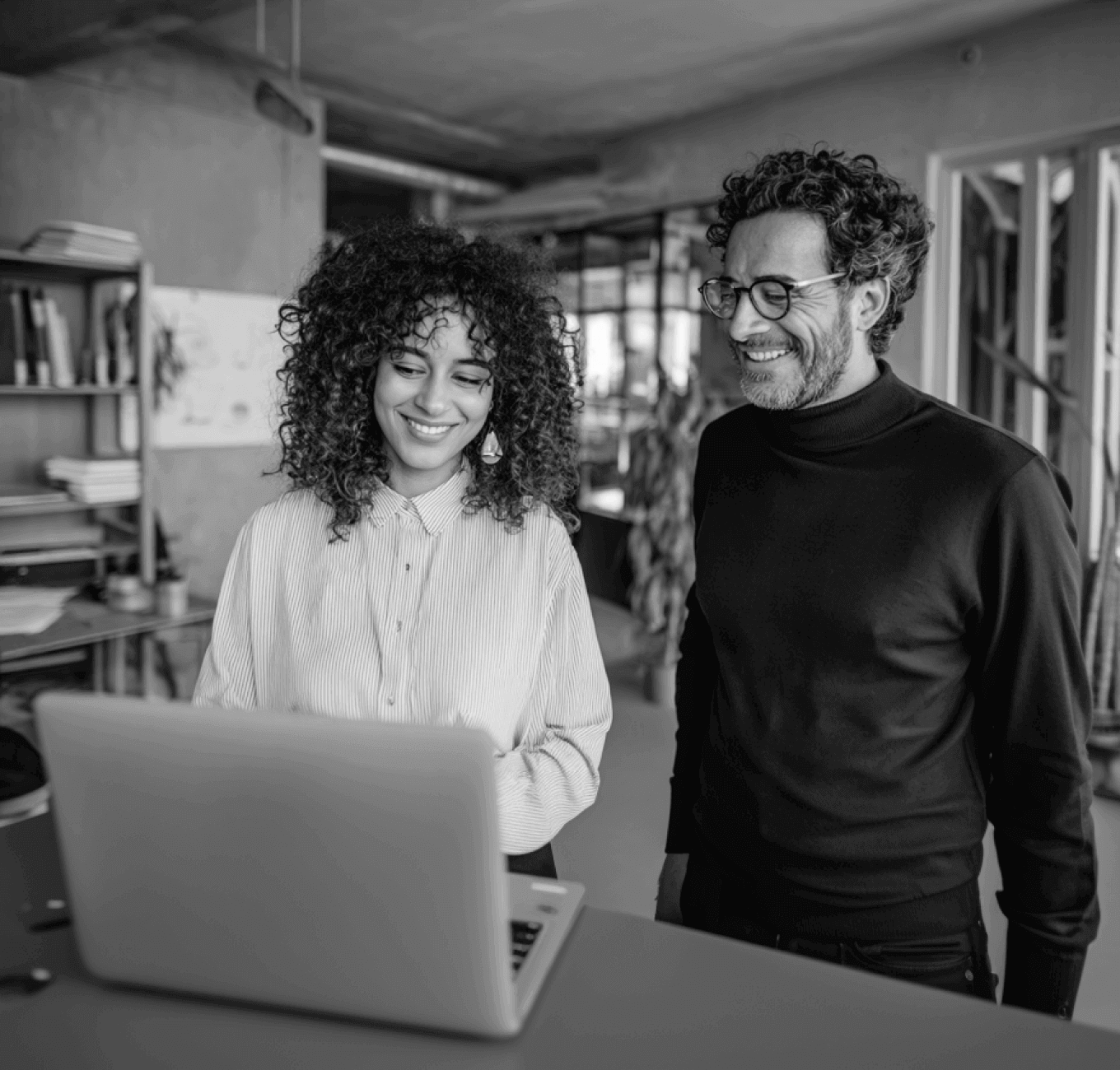 Colleagues Collaborating At Laptop In Modern Office PromptEngine Webflow Template | BRIX Template