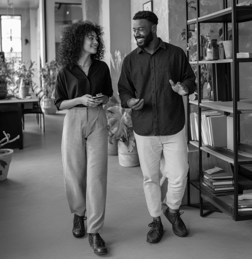 Colleagues Walking And Discussing Ideas In Modern Workspace PromptEngine Webflow Template | BRIX Template