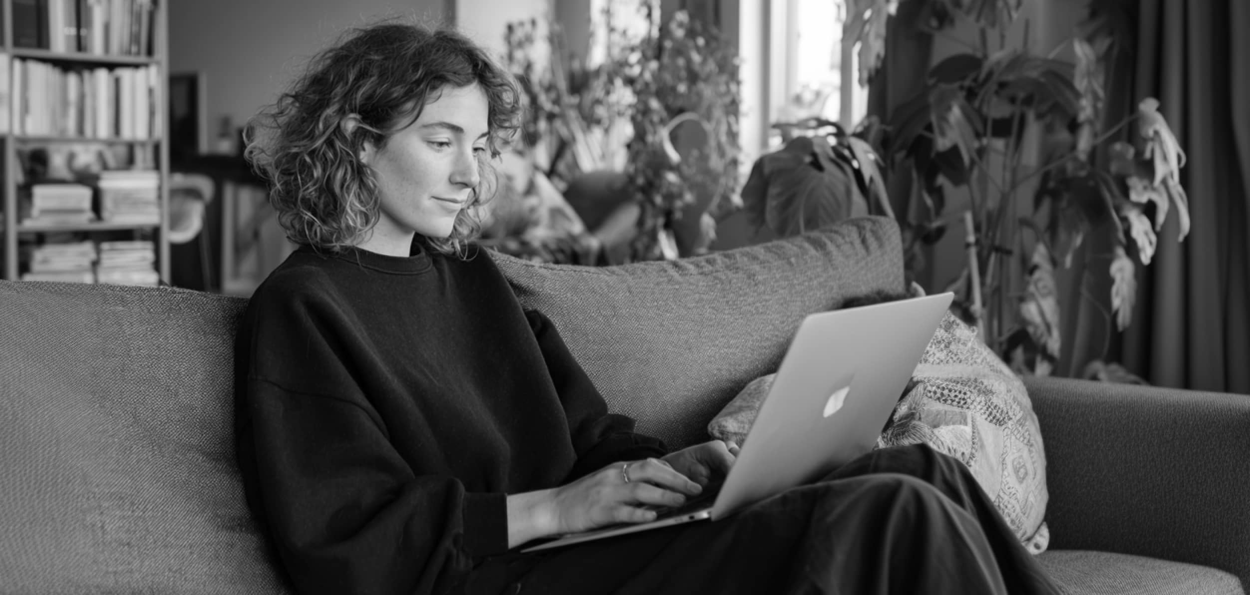 Woman Using Laptop On Cozy Sofa At Home PromptEngine Webflow Template | BRIX Template