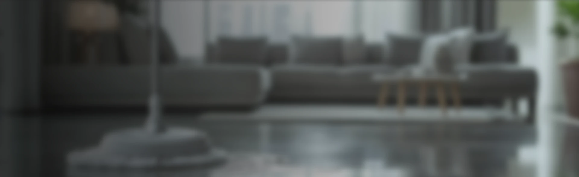 Blurred image of a modern living room with a sofa and a coffee table.