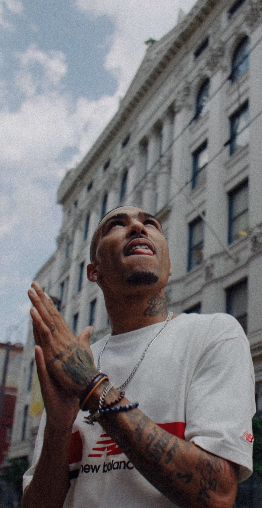 A model posing in the middle of a Baltimore street for a commercial production shoot for New Balance.