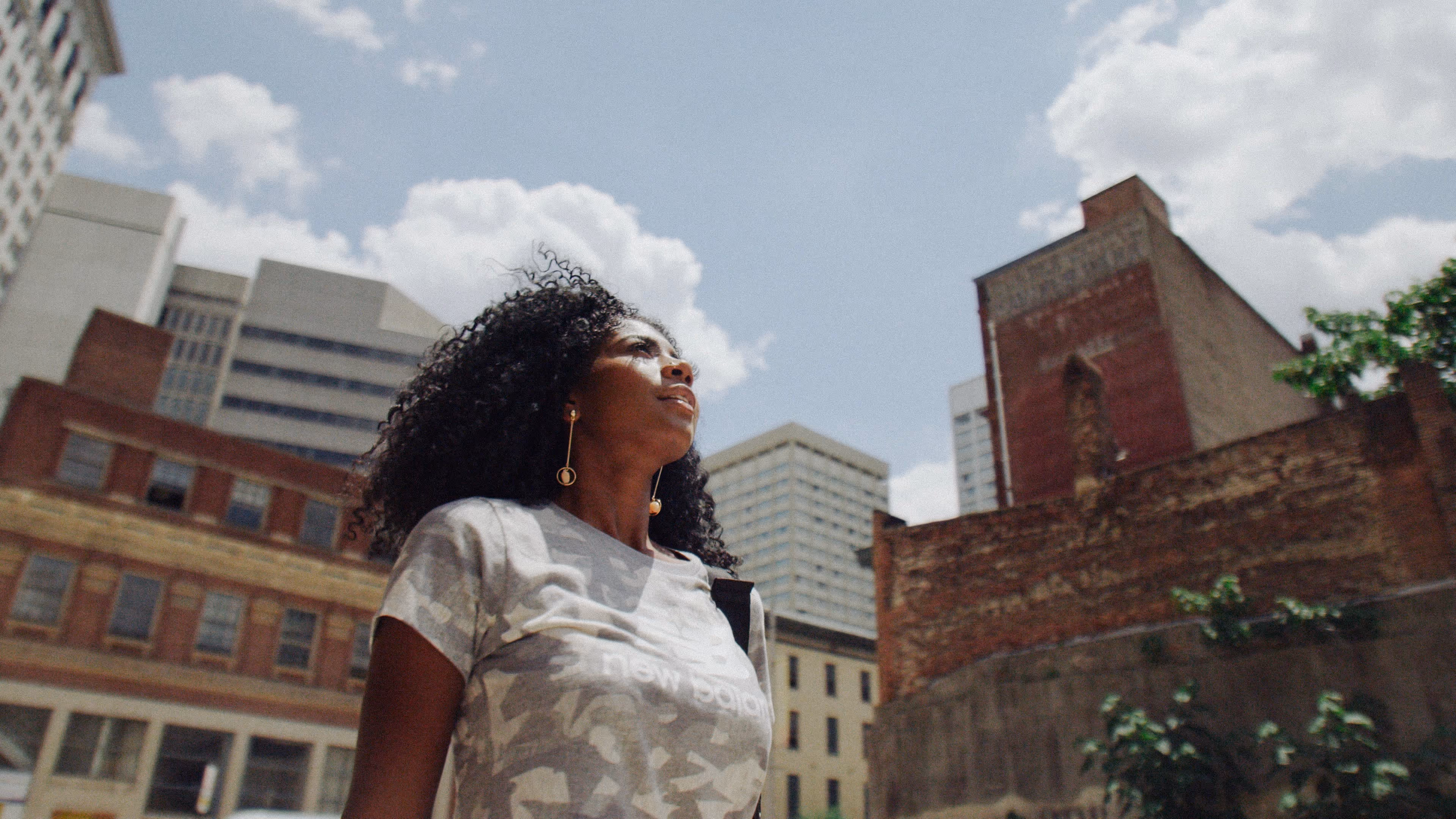 A female model posing during video production filming for a social media campaign for New Balance.