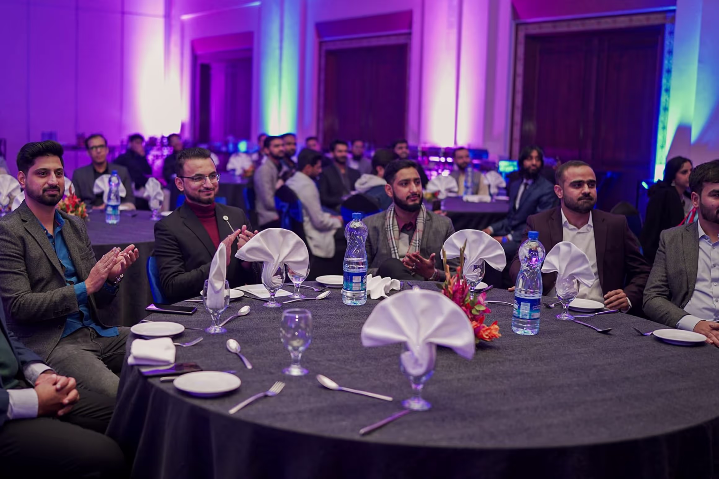 A group of men seated at a table during an annual dinner.