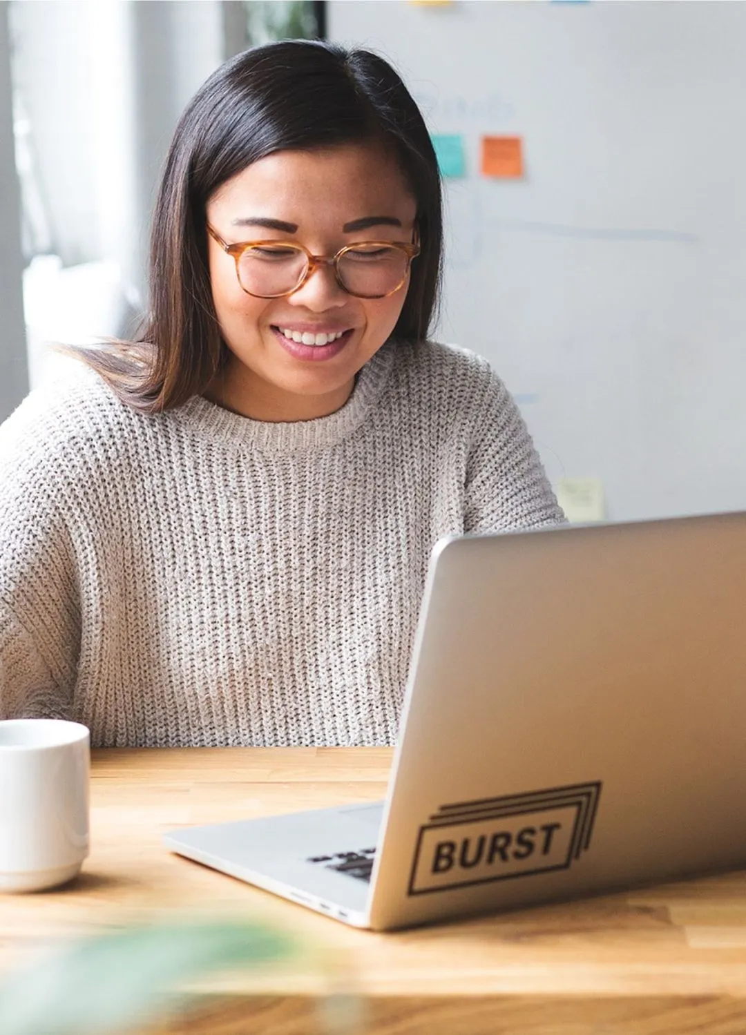 a teenage girl studying on a laptop in a library - wisual
